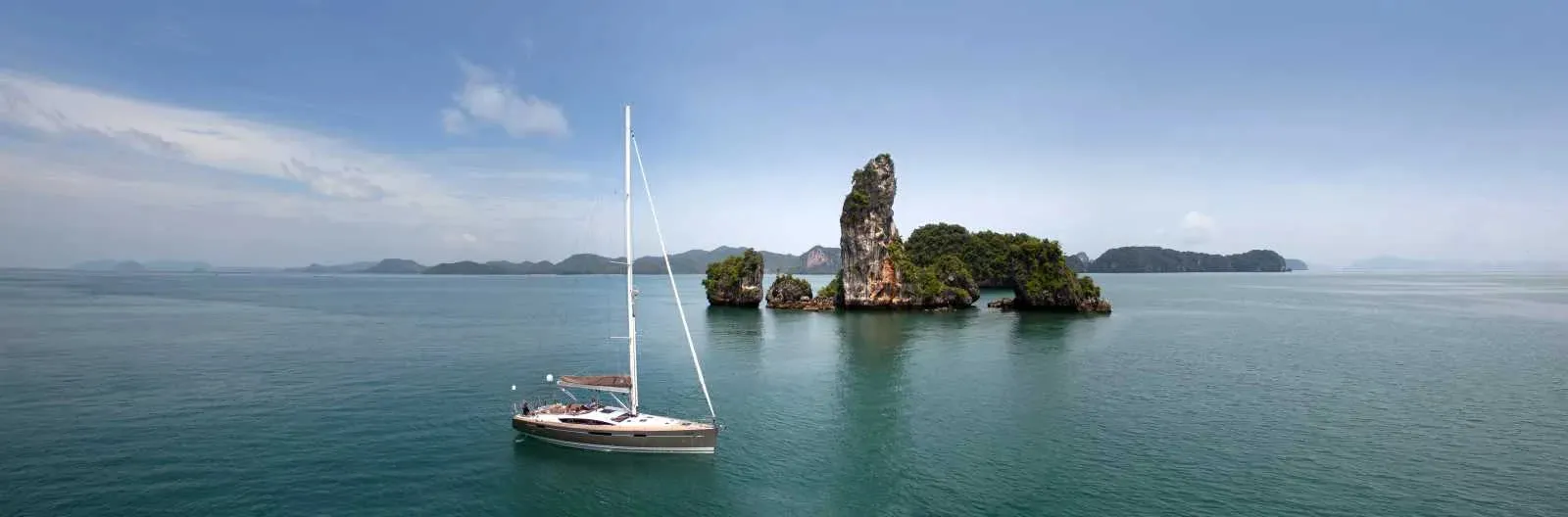 A Jeanneau yacht at anchor among limestone islands